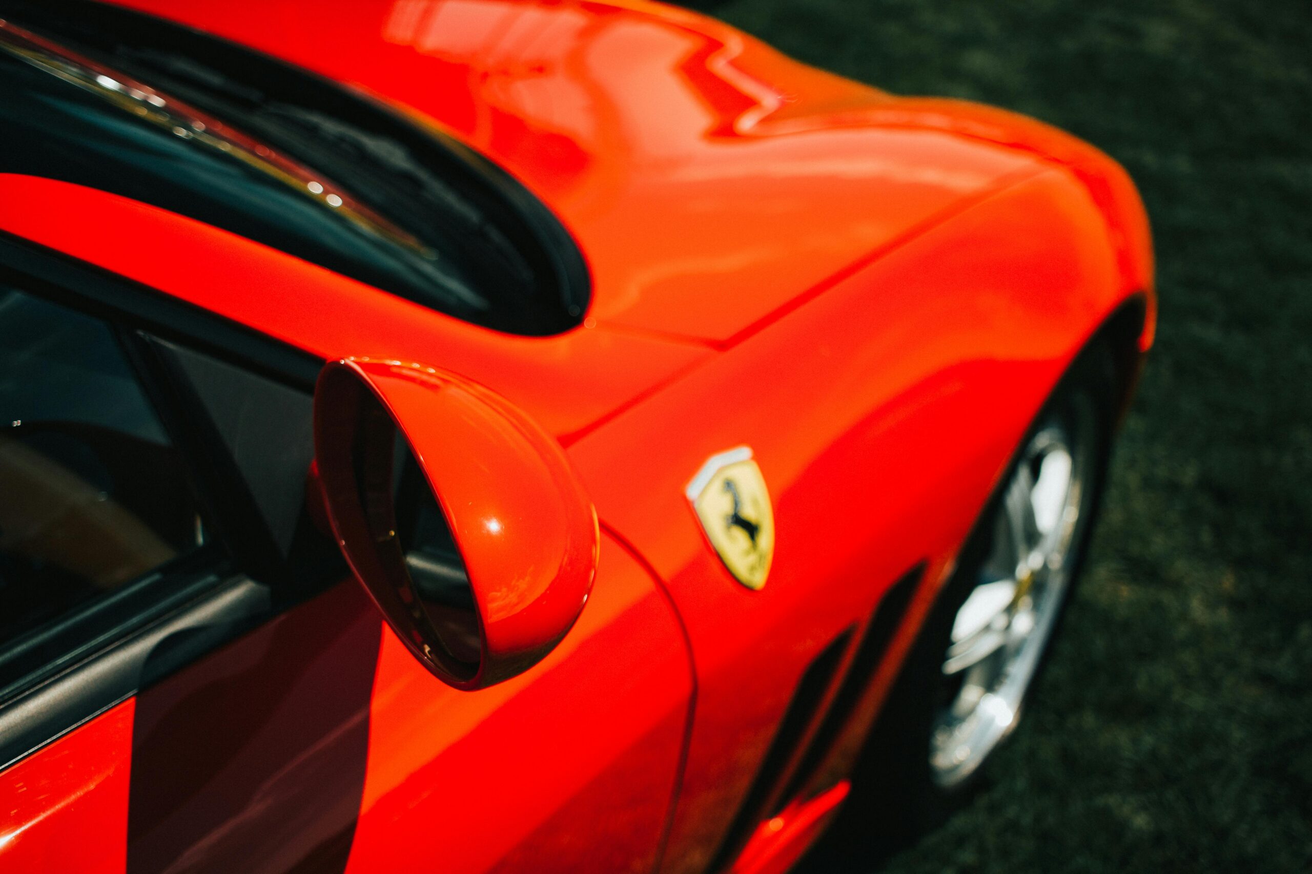 Close-up of a restored red Ferrari at an outdoor car show in Farmington, CT.